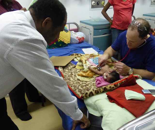 kevin examining the baby girl