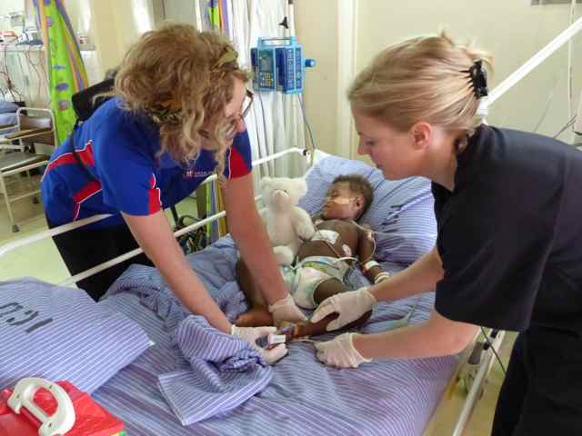 Megan helping a patient in ICU